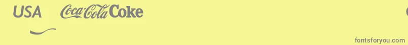 フォントCocacola – 黄色の背景に灰色の文字