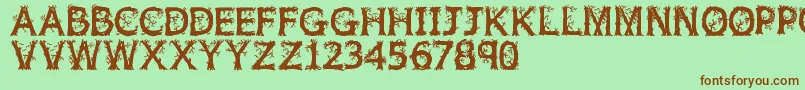 フォントJfwildwood – 緑の背景に茶色のフォント