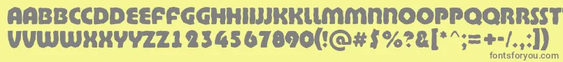 BighaustitulbrkExtrabold-fontti – harmaat kirjasimet keltaisella taustalla