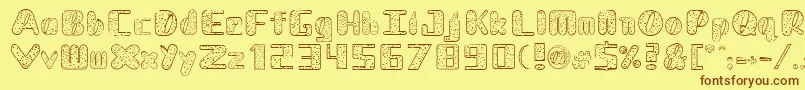 NadcDalmatian-Schriftart – Braune Schriften auf gelbem Hintergrund