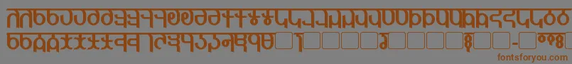 フォントQijomiBold – 茶色の文字が灰色の背景にあります。