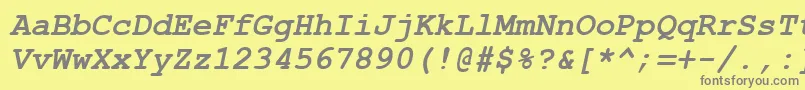 フォントAxccrtbi – 黄色の背景に灰色の文字