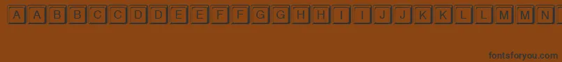 フォントKeystroke – 黒い文字が茶色の背景にあります