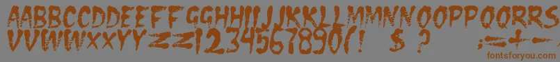 フォントDseraserc – 茶色の文字が灰色の背景にあります。