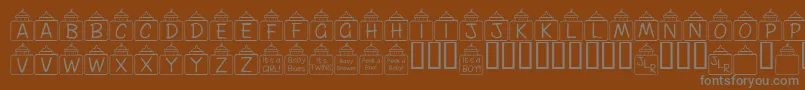 FlPeekababy-Schriftart – Graue Schriften auf braunem Hintergrund