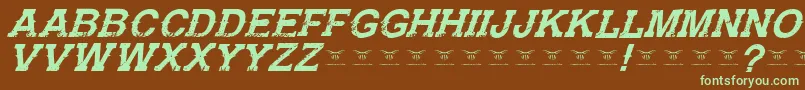 フォントGunfighteracademyItalic – 緑色の文字が茶色の背景にあります。