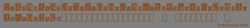 フォントCarrickCapitals – 茶色の文字が灰色の背景にあります。