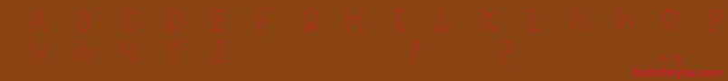 フォントHumancap – 赤い文字が茶色の背景にあります。