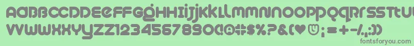 Plush-fontti – harmaat kirjasimet vihreällä taustalla