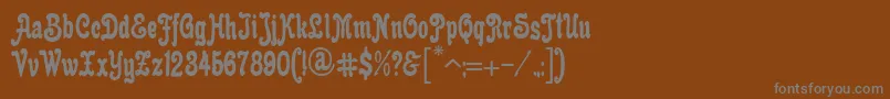 AnfisaGrotesk-fontti – harmaat kirjasimet ruskealla taustalla
