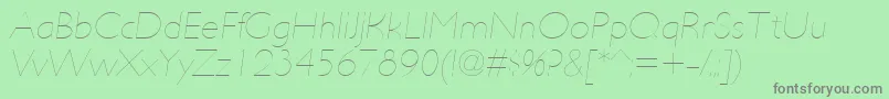 Fonte UltimapdabHairlineitalic – fontes cinzas em um fundo verde