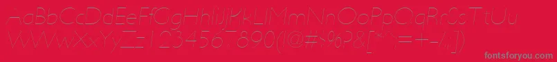 Fonte UltimapdabHairlineitalic – fontes cinzas em um fundo vermelho