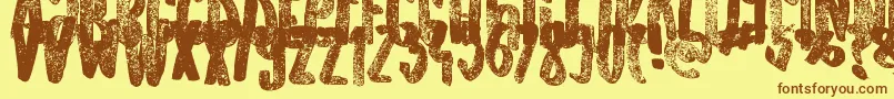 フォントOldOriginals – 茶色の文字が黄色の背景にあります。