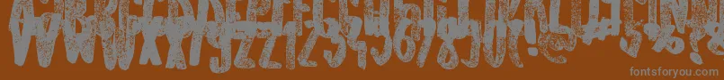 OldOriginals-fontti – harmaat kirjasimet ruskealla taustalla