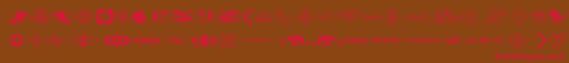 フォントTypeembellishmentstwo – 赤い文字が茶色の背景にあります。