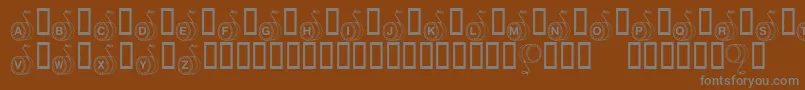 KrYoyo-fontti – harmaat kirjasimet ruskealla taustalla