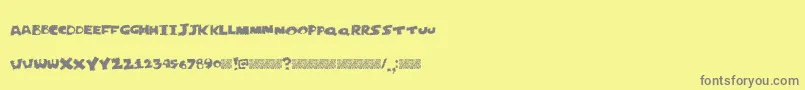 Justperforate-fontti – harmaat kirjasimet keltaisella taustalla