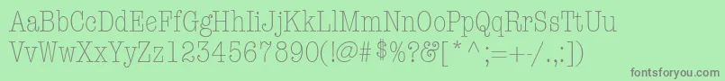 ItcAmericanTypewriterLtLightCondensedAlternate-fontti – harmaat kirjasimet vihreällä taustalla