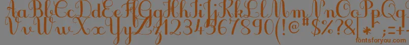 フォントJbcursiveV3Bold – 茶色の文字が灰色の背景にあります。