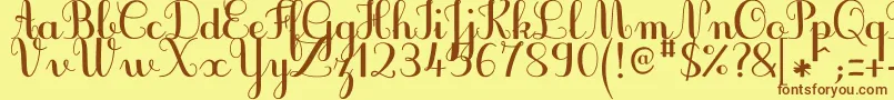 フォントJbcursiveV3Bold – 茶色の文字が黄色の背景にあります。