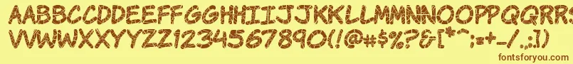 フォントKomikrak – 茶色の文字が黄色の背景にあります。