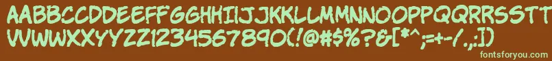 フォントKomikap – 緑色の文字が茶色の背景にあります。
