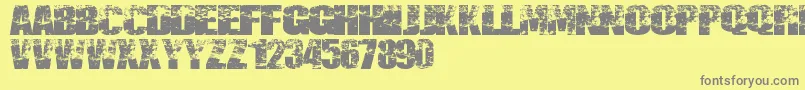 Fonte Destruccion – fontes cinzas em um fundo amarelo