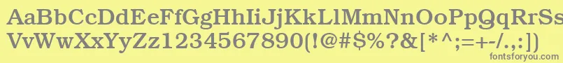 ItcBookmanLtMedium-fontti – harmaat kirjasimet keltaisella taustalla