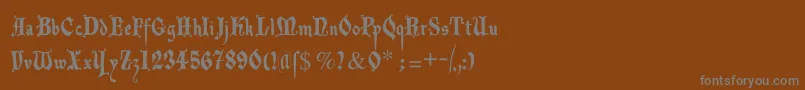 Decadentafrax-fontti – harmaat kirjasimet ruskealla taustalla