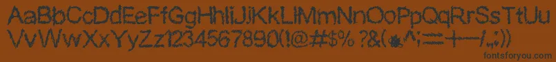 SkriblerRegular Font – Black Fonts on Brown Background