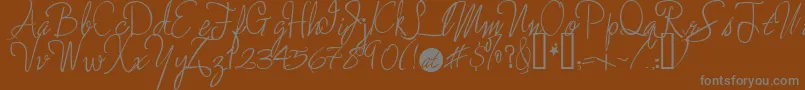 Шрифт Enchantedprairiedog – серые шрифты на коричневом фоне