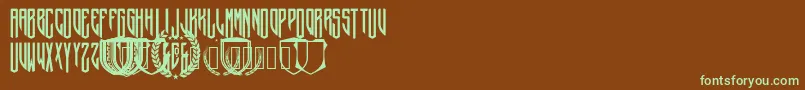 フォントCrepitusMonogram – 緑色の文字が茶色の背景にあります。