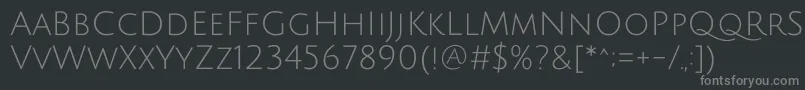 JuliussansoneRegular-fontti – harmaat kirjasimet mustalla taustalla