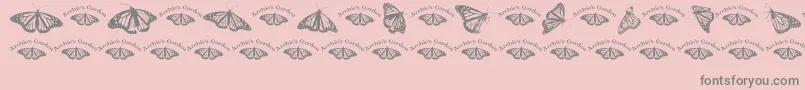 Wlroyalflutterdingbats-Schriftart – Graue Schriften auf rosa Hintergrund
