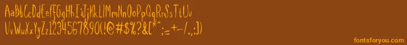 Fonte Spilmrg – fontes laranjas em um fundo marrom