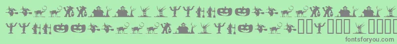 SilbooettesTryout-fontti – harmaat kirjasimet vihreällä taustalla