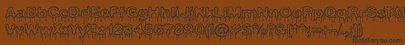 フォントPlasmaDripEmptyBrk – 黒い文字が茶色の背景にあります
