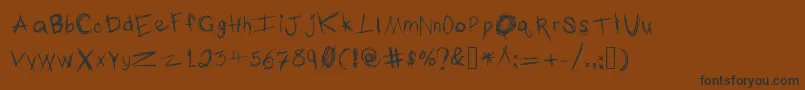 フォントTheTypingOfAMadman – 黒い文字が茶色の背景にあります