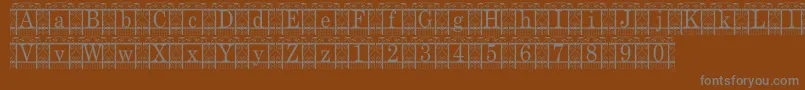 TheGarden-fontti – harmaat kirjasimet ruskealla taustalla