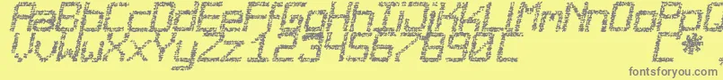 Desgastada-fontti – harmaat kirjasimet keltaisella taustalla