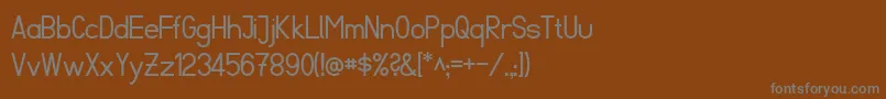 FibelSued-fontti – harmaat kirjasimet ruskealla taustalla