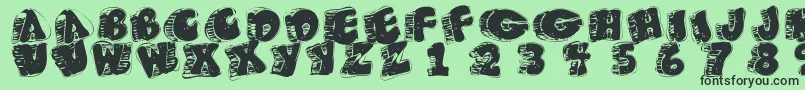 Fatfloralphabetxperimental Font – Black Fonts on Green Background