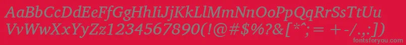 CharisSilItalic-fontti – harmaat kirjasimet punaisella taustalla