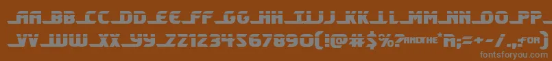 Shiningheraldlaser-fontti – harmaat kirjasimet ruskealla taustalla