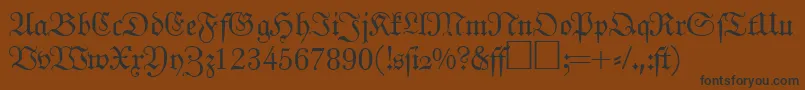 フォントJohannfrakturRegularDb – 黒い文字が茶色の背景にあります