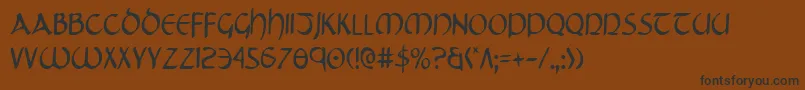 フォントTristramCondensed – 黒い文字が茶色の背景にあります