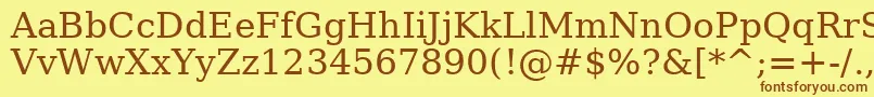 フォントAeAlmohanad – 茶色の文字が黄色の背景にあります。