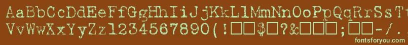 フォントBatikRegular – 緑色の文字が茶色の背景にあります。