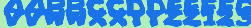 Czcionka PrehistoricCaveman – niebieskie czcionki na zielonym tle