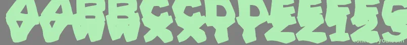 PrehistoricCaveman Font – Green Fonts on Gray Background